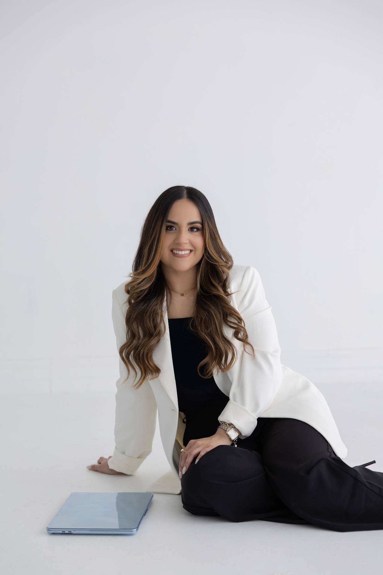 Mariangela Dominguez standing with laptop.